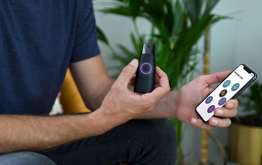 A man is holding a cell phone and the device